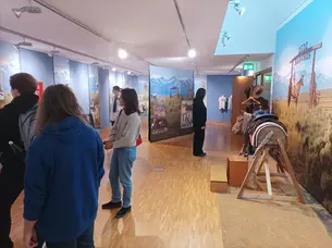 students reading the displays in the exhibition room