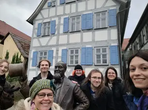 group of students pose in front of the levi strauss museum in buttenheim